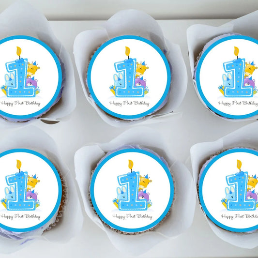 cute cupcake toppers with a blue 1 and illustrated characters on white frosted cupcakes
