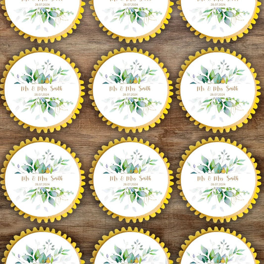 Personalised Cupcake Toppers with Botanical greenery with gold letting in the middle with a Mr & Mrs name and date of event placed on cupcakes with yellow cases.