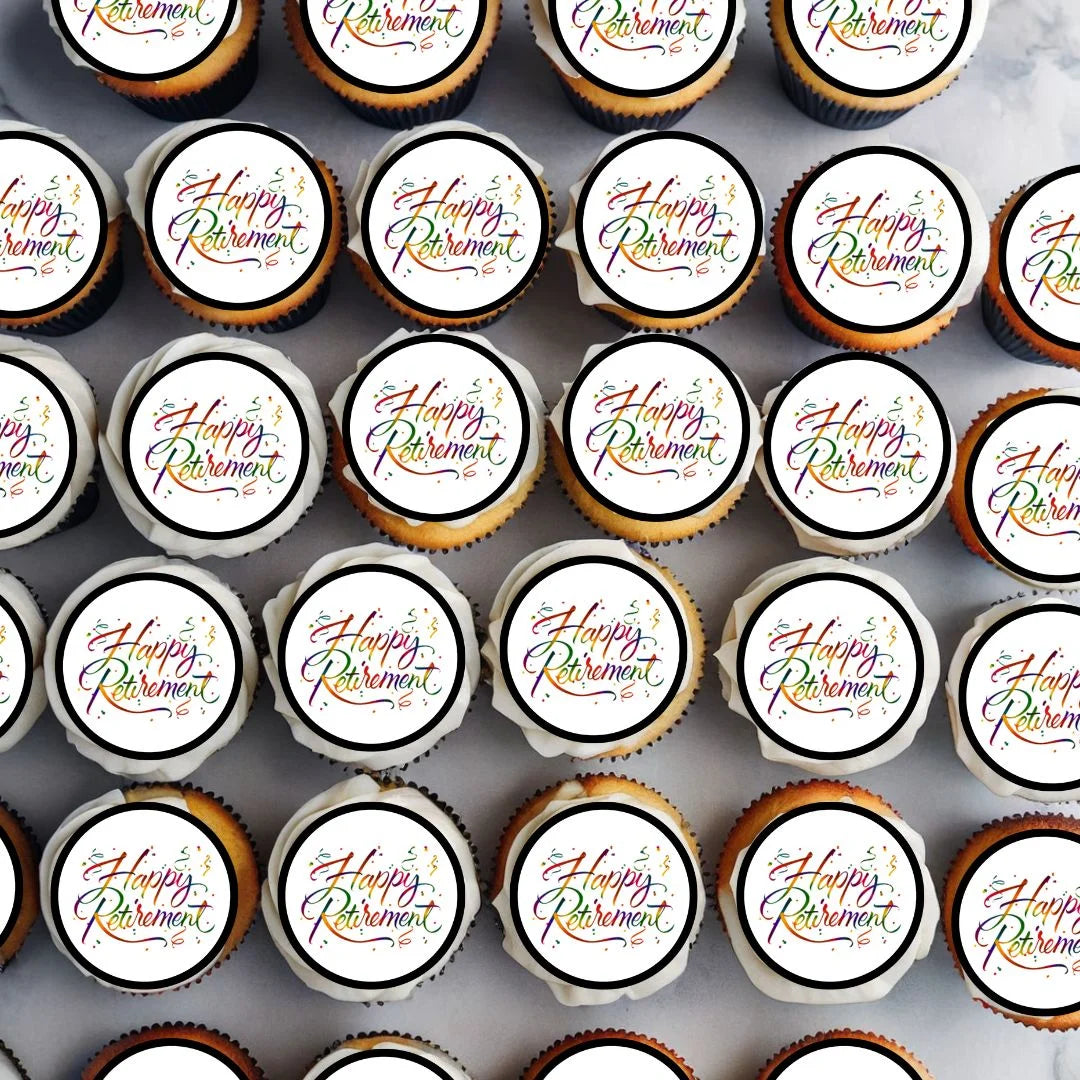 large quantity of white frosted cupcakes decorated with 'Happy retirement' edible cupcake toppers made by Cian's Cupcake Toppers