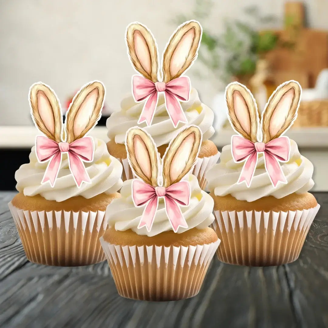 Pink coquette bow edible wafer bunny ears, placed on white frosted cupcakes