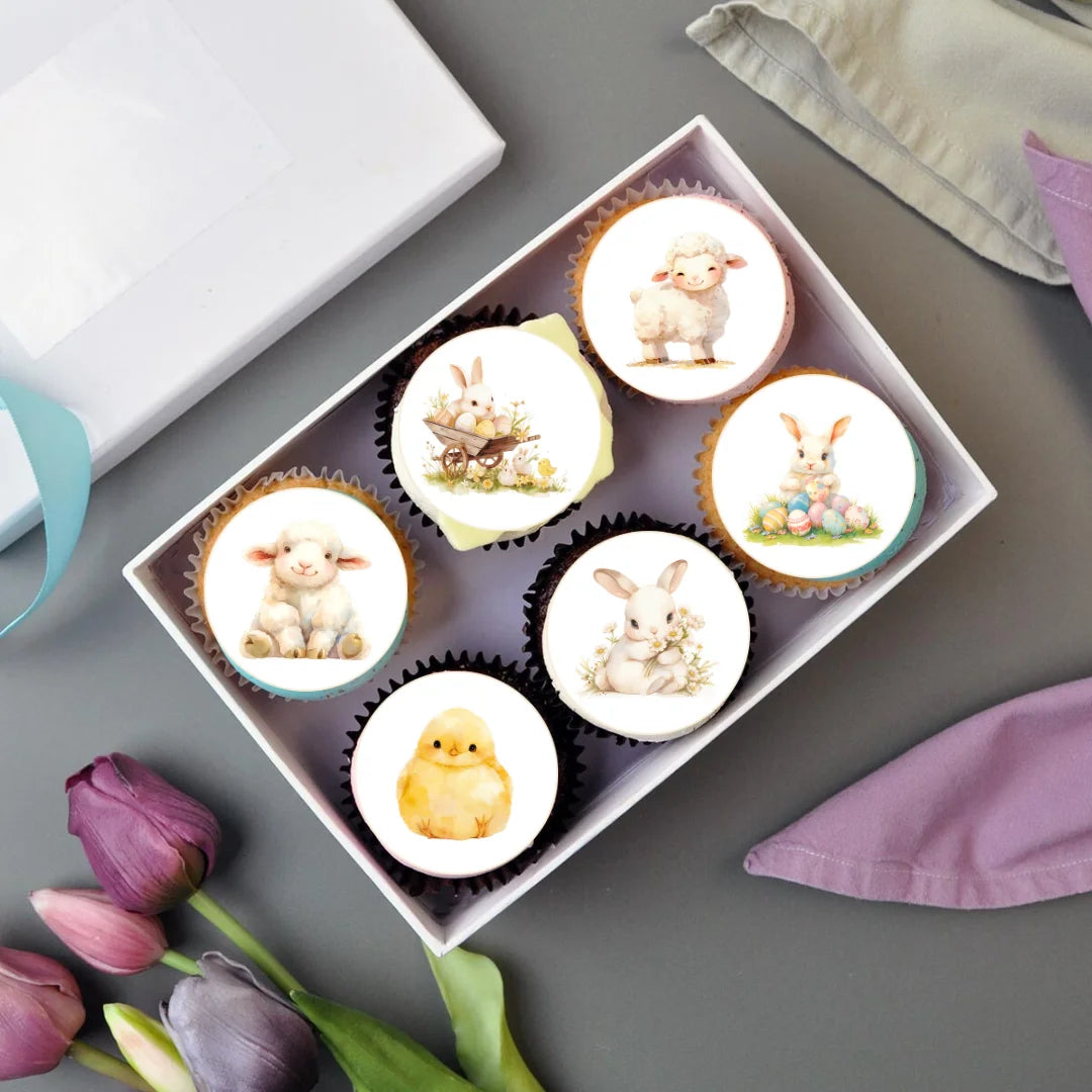 Cute spring animal edible cupcake toppers, placed on frosted cupcakes and in a cake box