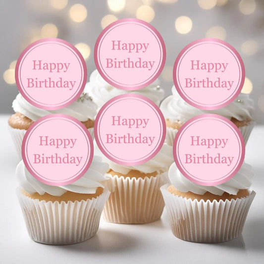 Pink happy birthday cupcake toppers placed on white frosted cupcakes