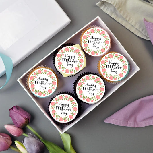 Pink Floral Mothers Day Cupcake Toppers on frosted cupcakes and in a box, with tulip flowers for decoration