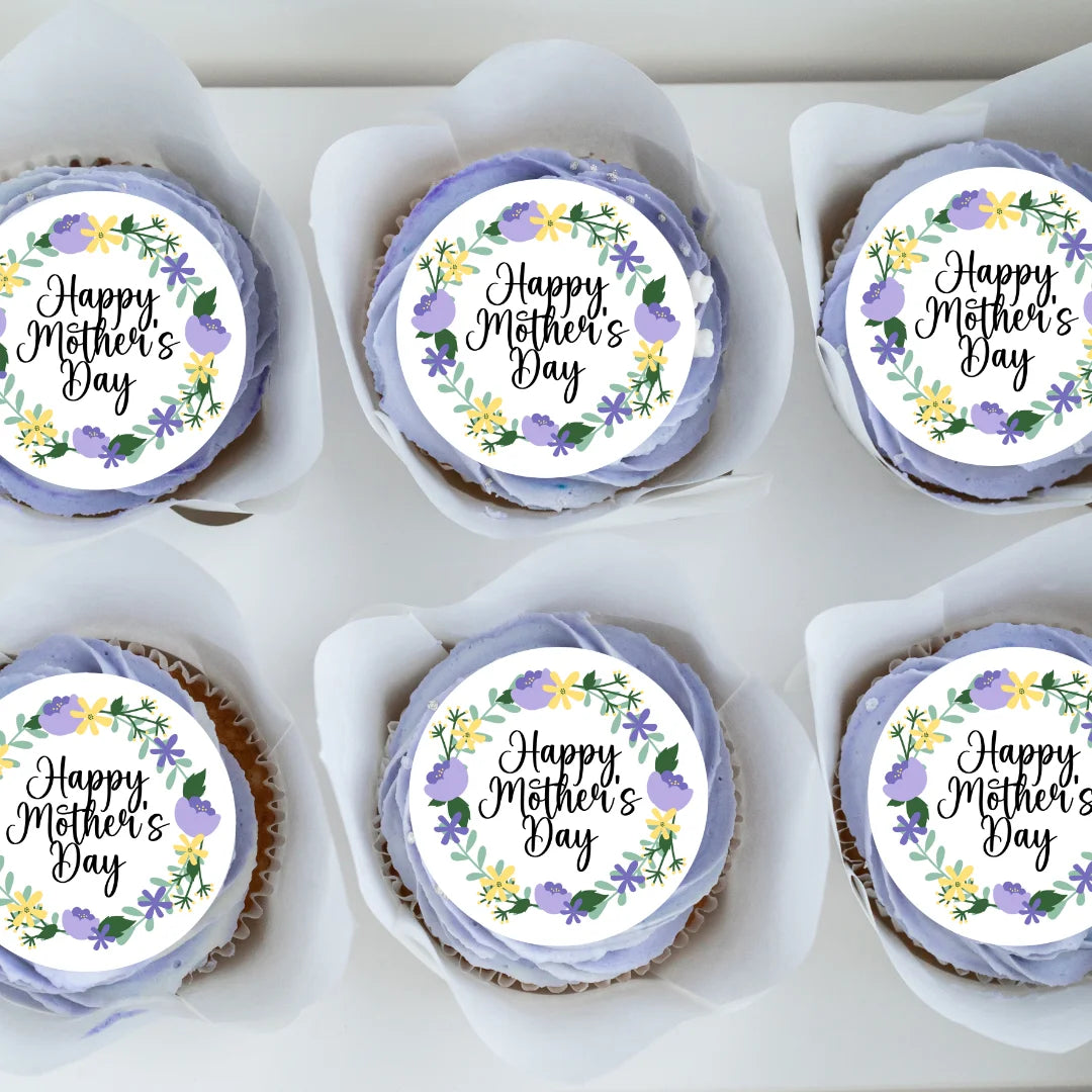 Purple floral mother's day edible toppers placed on purple frosted cupcakes