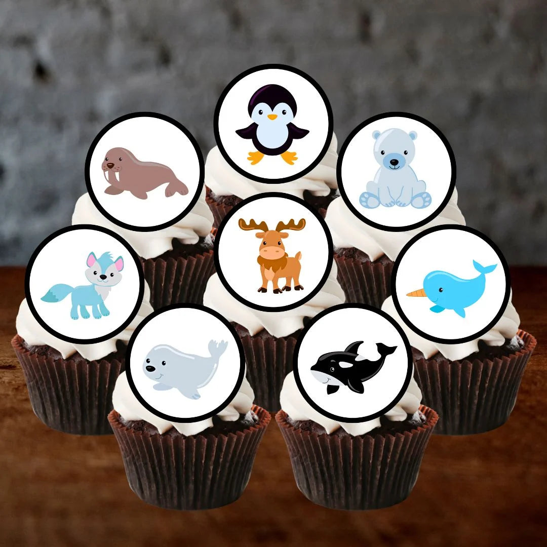chocolate cupcakes with white frosting and arctic themed animal cake toppers