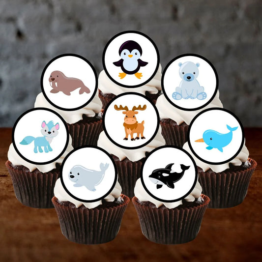 chocolate cupcakes with white frosting and arctic themed animal cake toppers
