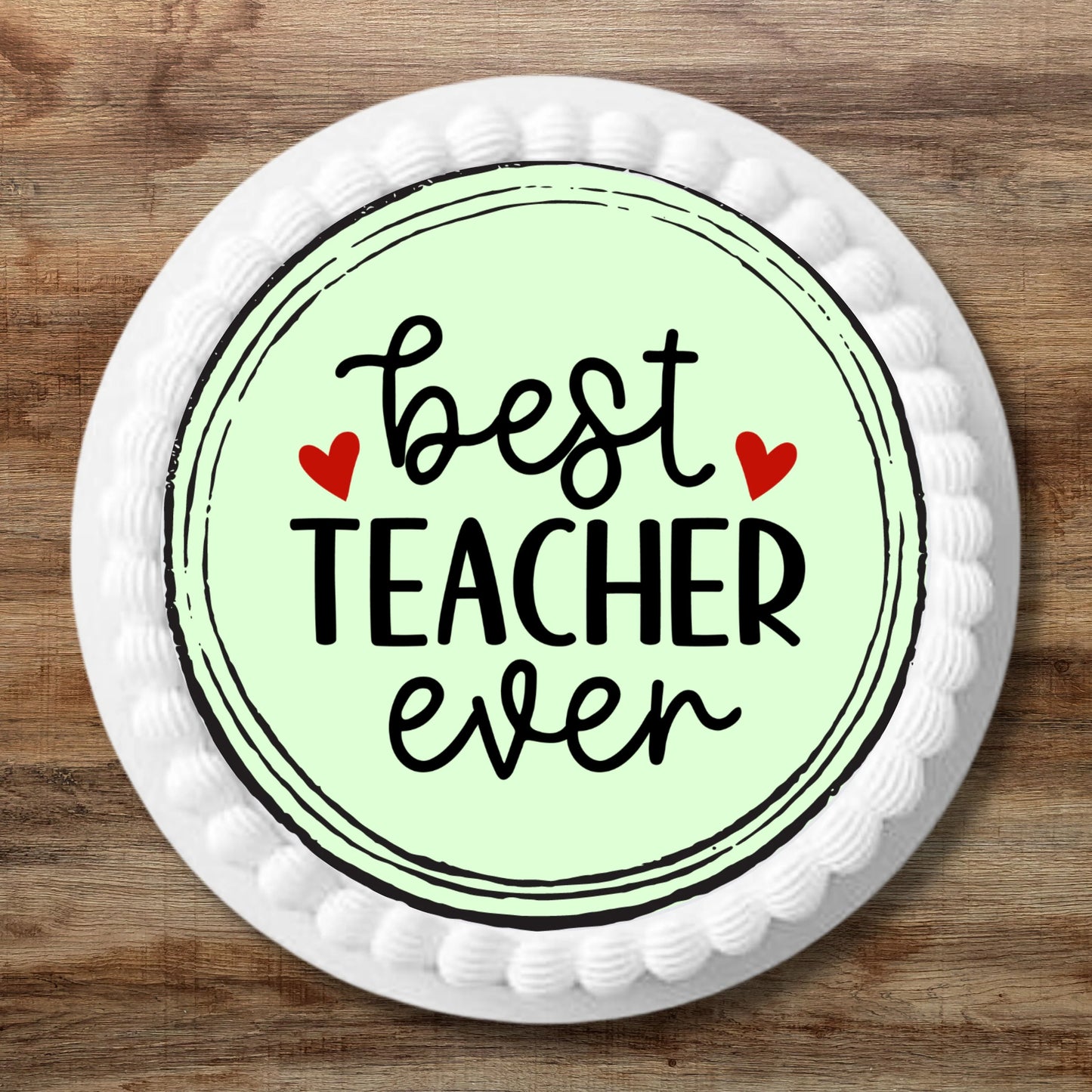 large Best Teacher Ever Edible cake Topper on a white frosted cake