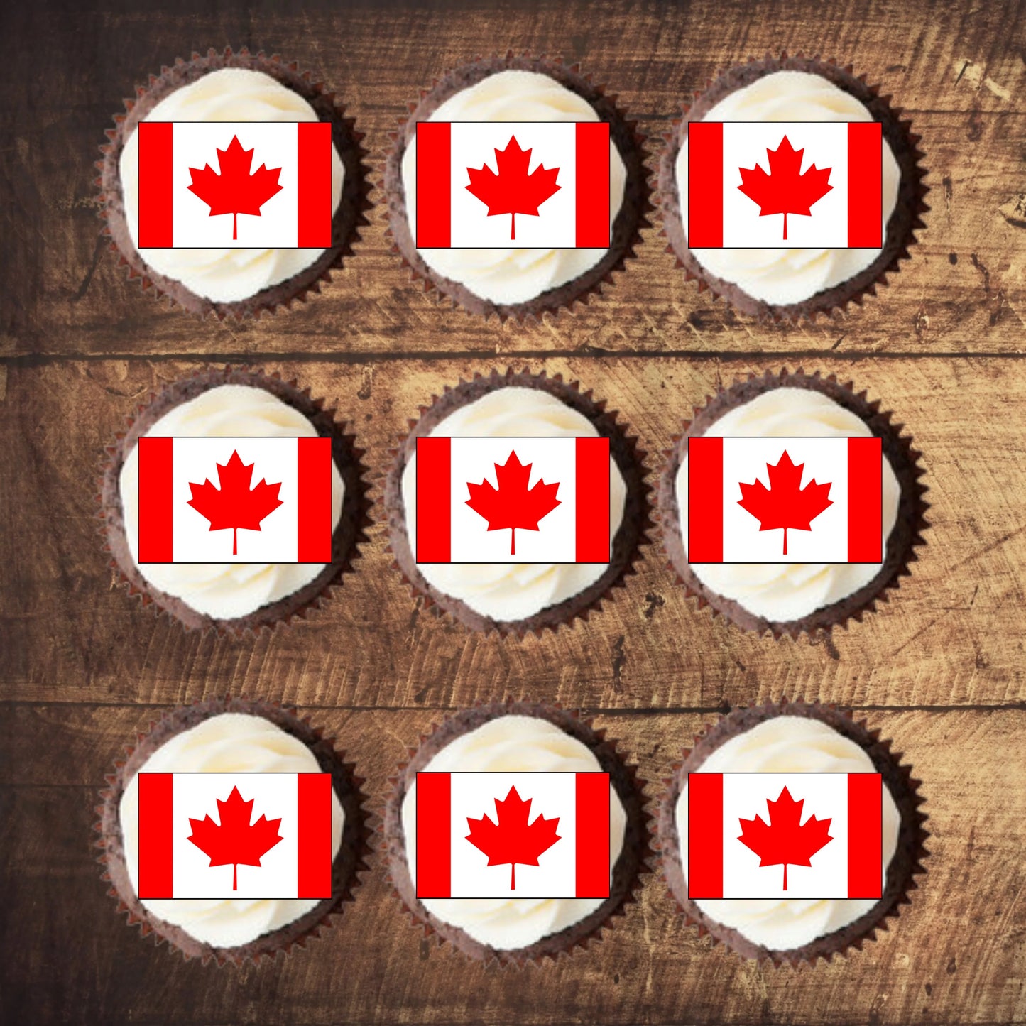 top view of Canadian Flag Edible Cupcake Toppers on chocolate cupcakes with white frosting