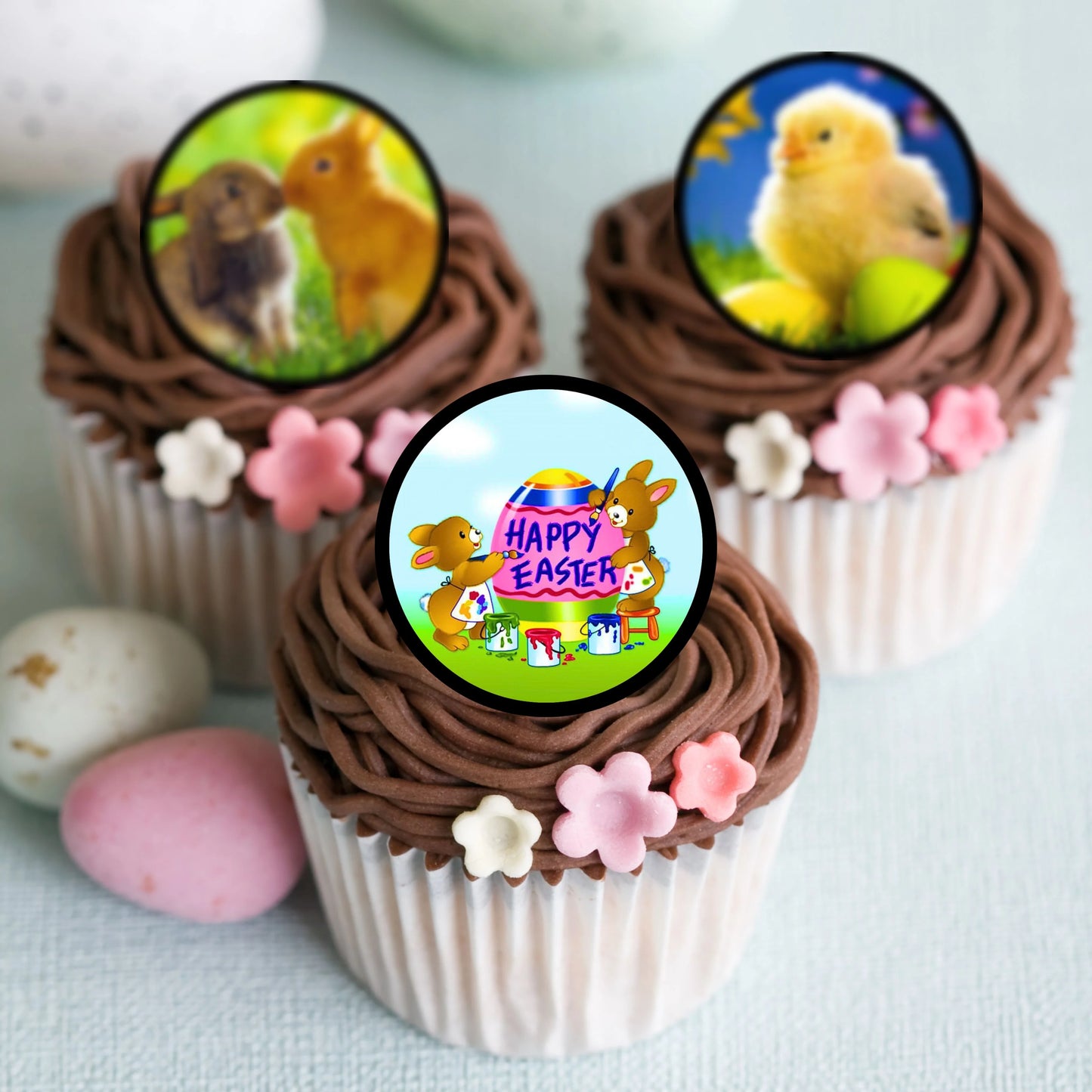 Easter Theme Edible Cupcake Toppers on chocolate frosted cupcakes with pink flowers