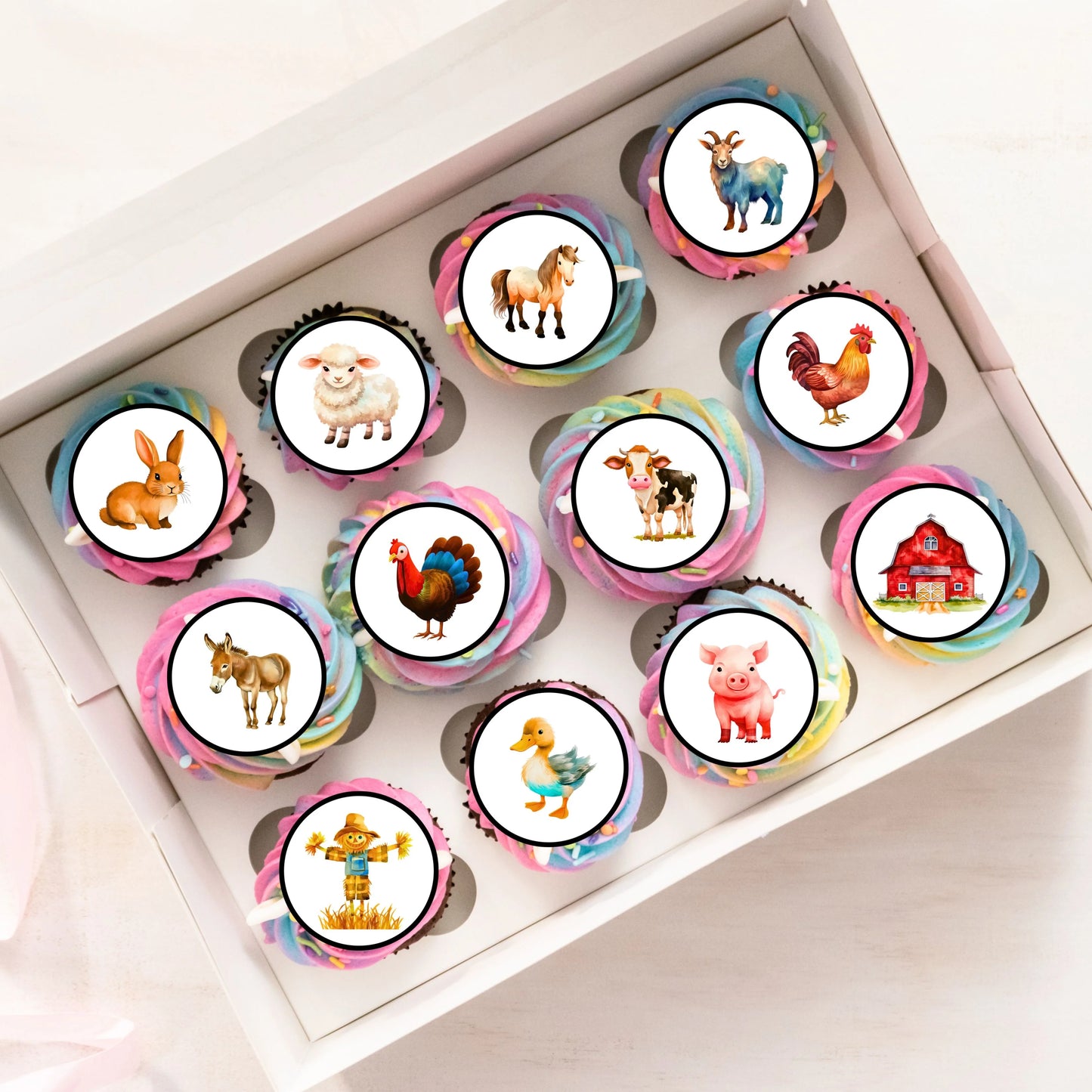 tray of frosted cupcakes decorated with farm animal themed cupcake toppers