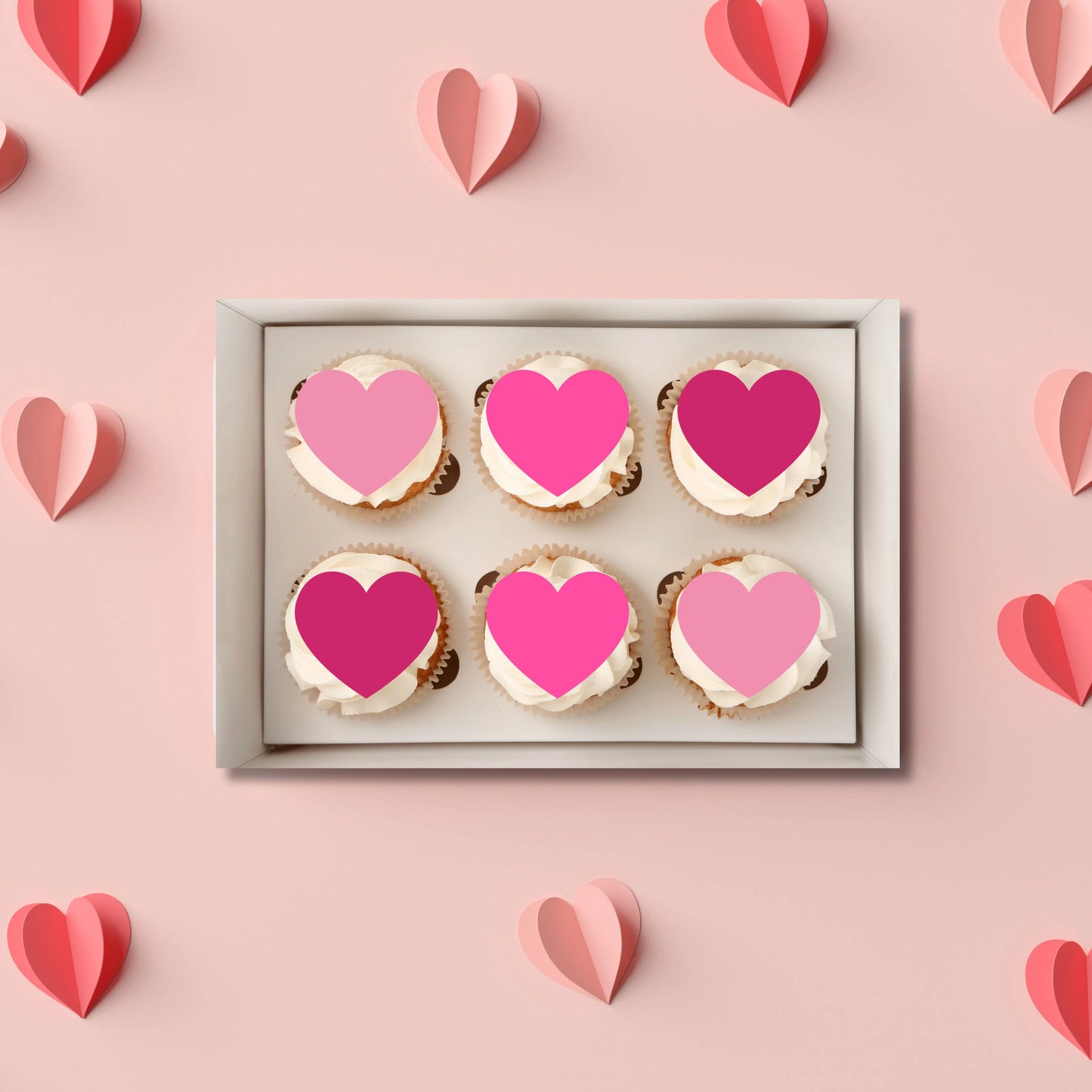 Pink Love Heart Edible Cupcake Toppers on white frosted cupcakes