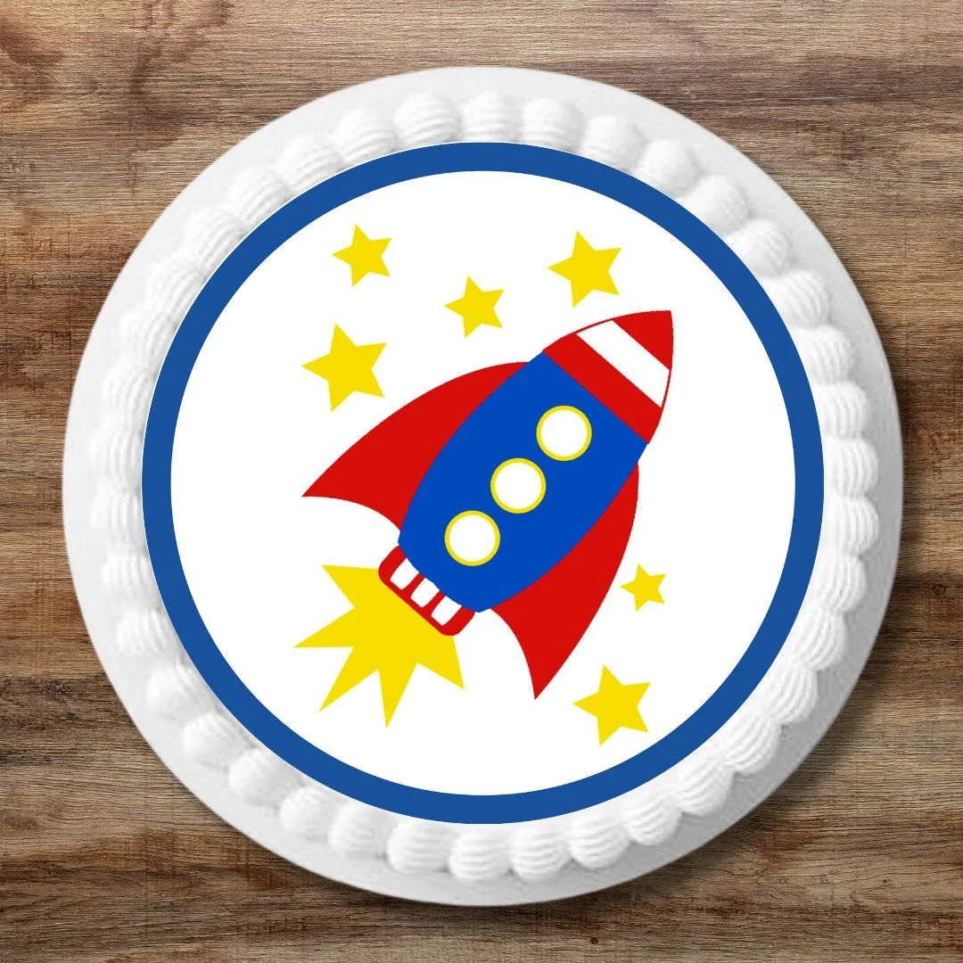 Rocket themed 7 inch cake topper on a large celebration cake with white frosting