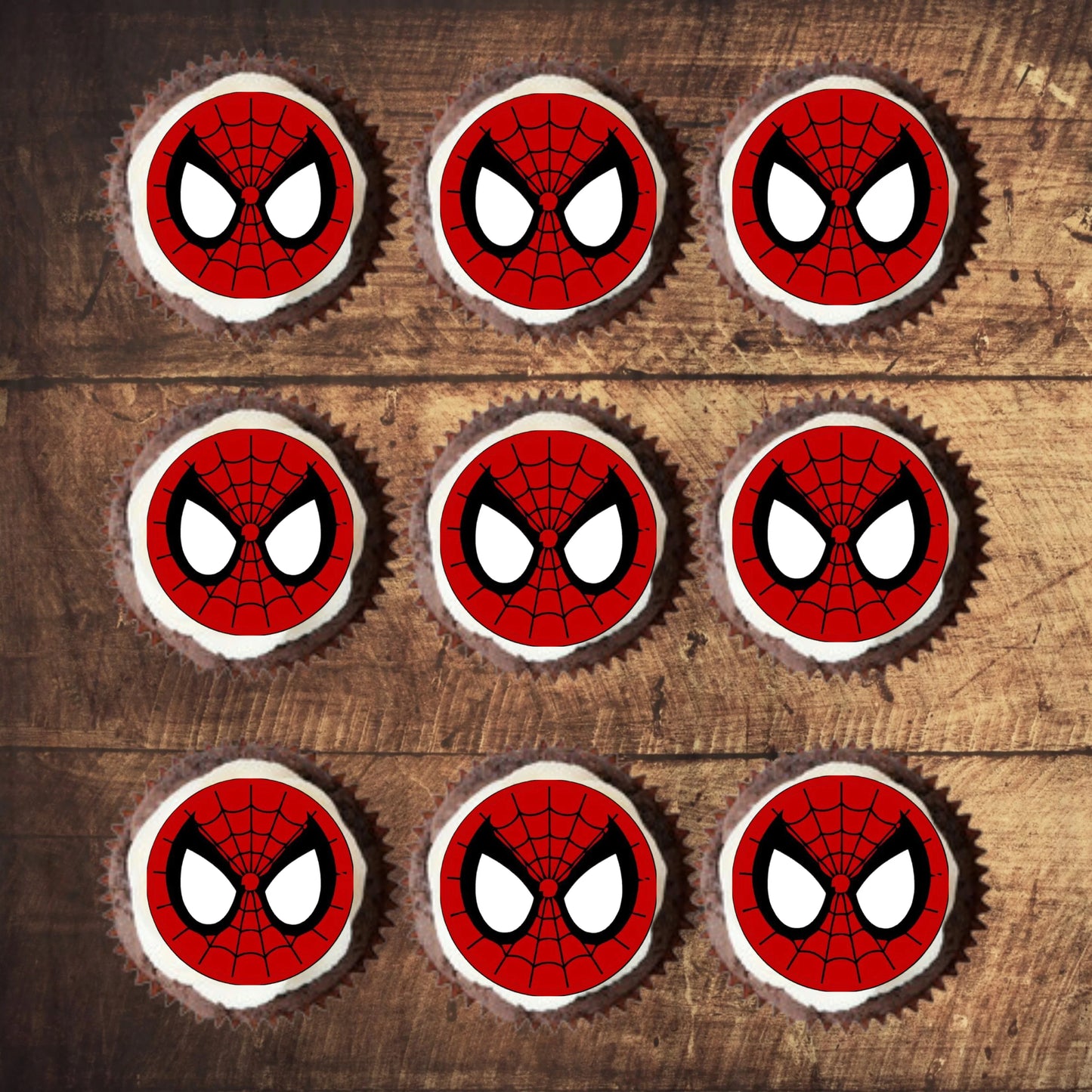 Spider-Man Face Edible Cupcake Toppers on chocolate cupcakes with white frosting