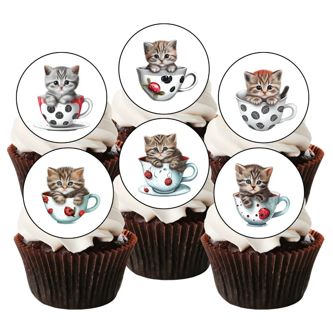 cupcakes with white frosting and illustrated cupcake toppers featuring cute cats in tea cups.