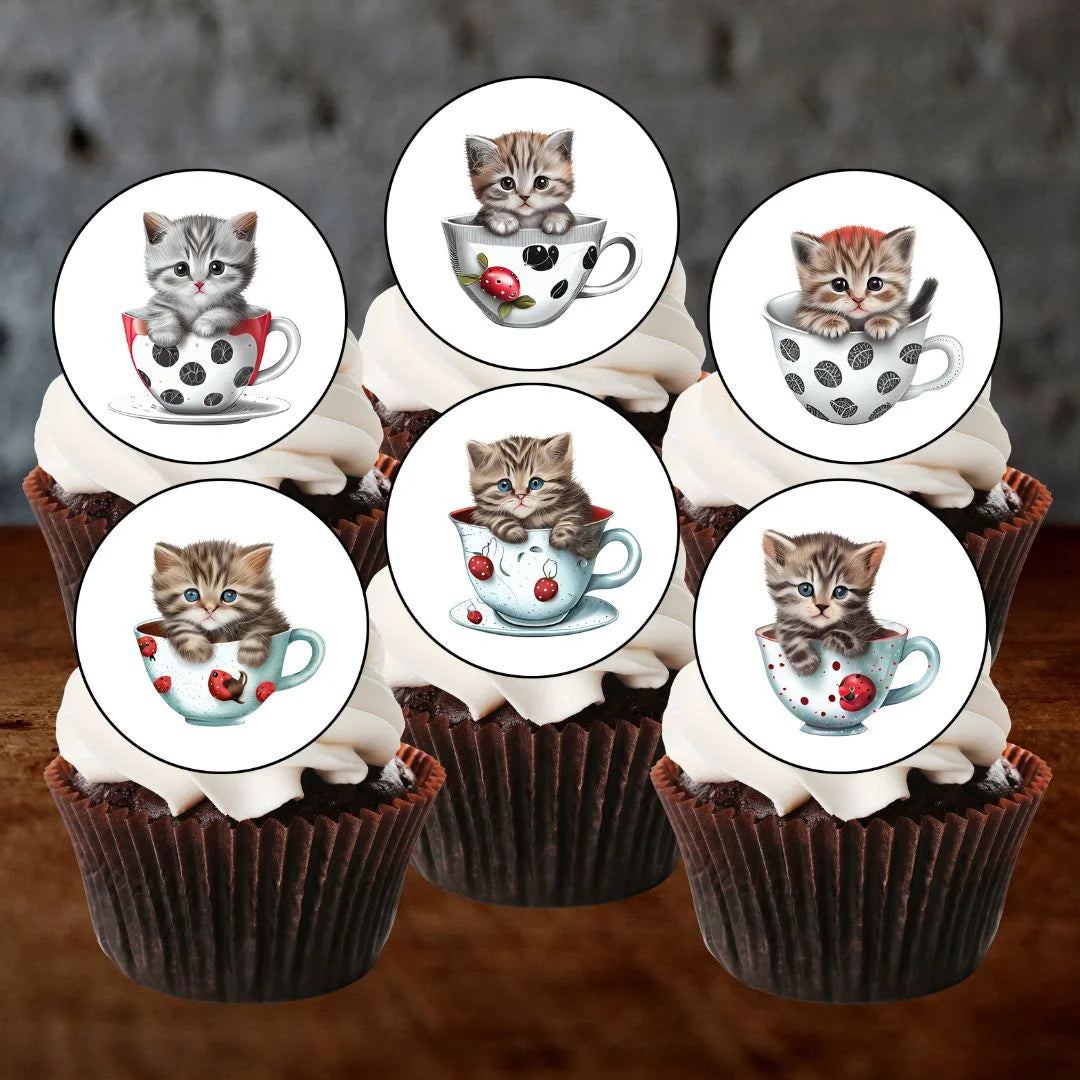 cupcakes with white frosting and illustrated cupcake toppers featuring cute cats in tea cups.