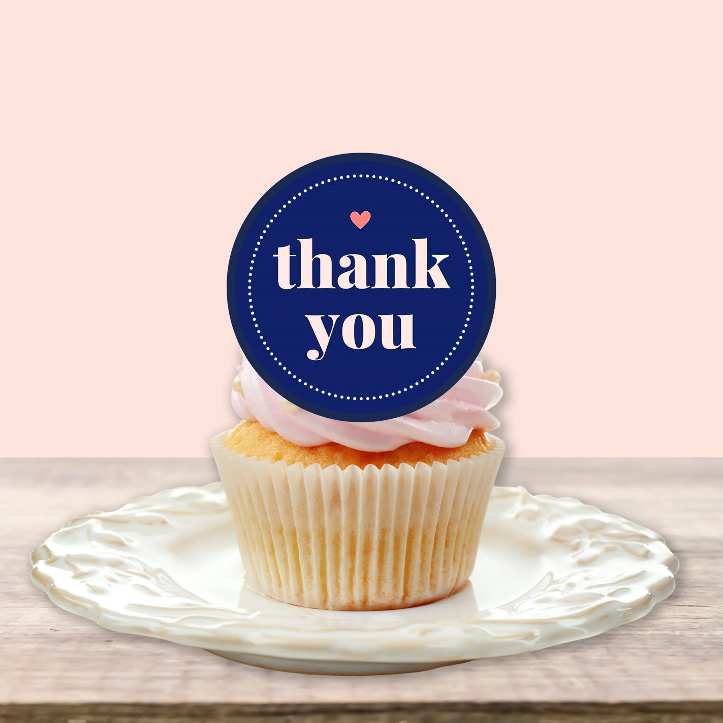 close up of a Thank You Blue Edible Cupcake Topper on a cupcake with pink frosting
