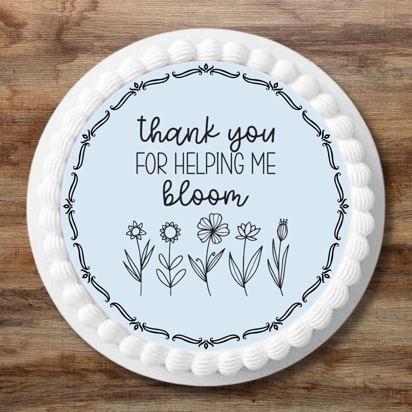 Thank You For Helping Me Bloom Edible cake Topper on a white frosted cakes
