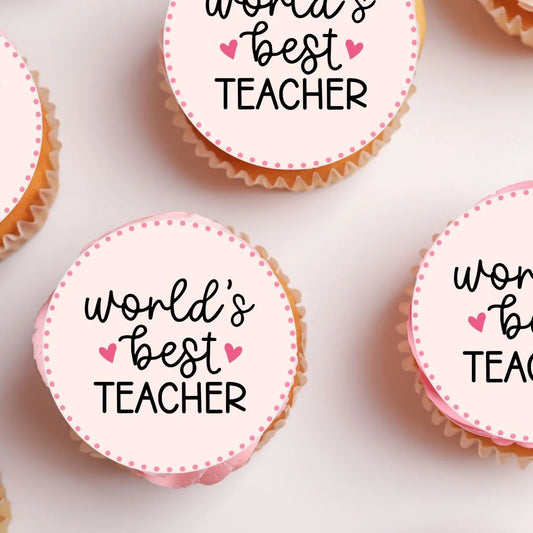 close up of Worlds Best Teacher Cupcake Toppers on pink frosted cupcakes