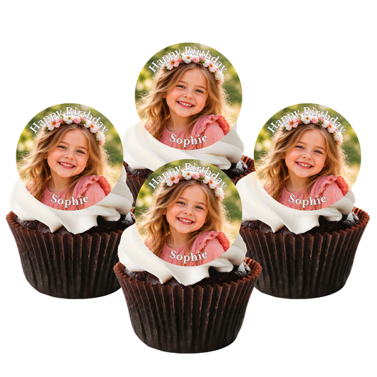 Four personalized birthday cupcake toppers featuring a photo of a smiling girl in a flower crown with the text 'Happy Birthday Sophie', displayed on chocolate cupcakes with white frosting against a white background.