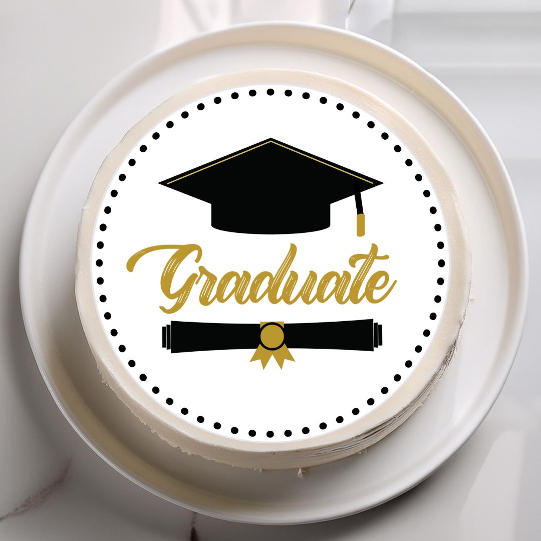Graduation-themed cake with a black and gold design on a white plate.