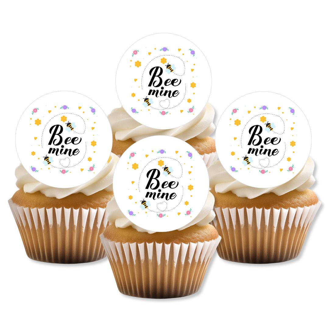 Cupcakes with 'Bee mine' toppers on a white background