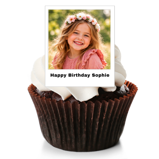 A chocolate cupcake in a brown paper liner with white frosting, topped with a printed photo topper that reads 'Happy Birthday Sophie' against a white background.