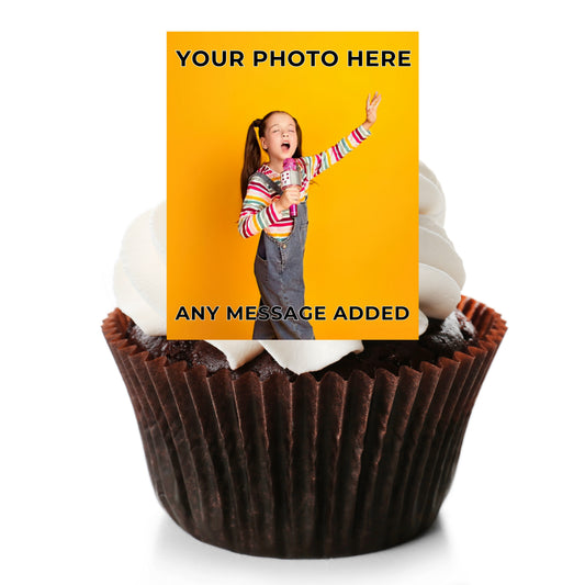 A custom photo cupcake topper displayed on top of a chocolate cupcake with white frosting. The topper features a bright yellow background with placeholder text 'YOUR PHOTO HERE' and 'ANY MESSAGE ADDED', along with a sample photo of a girl.