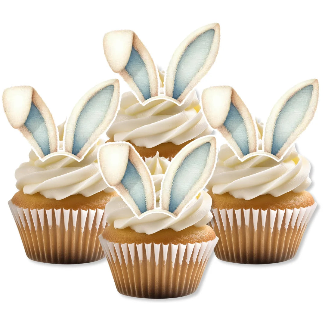 Blue and white wafer bunny ears, placed on hite frosted cupcakes.