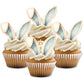 Blue and white wafer bunny ears, placed on hite frosted cupcakes.