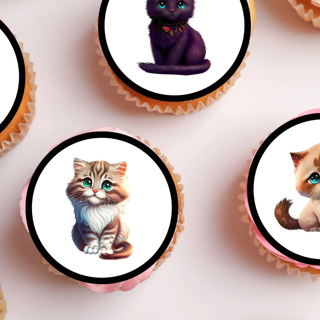 close up view of  circular cupcake toppers featuring cartoon style cats. The toppers are on frosted cupcakes with a pink background