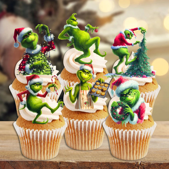 Green Grinch Edible Cake Decorations On White Cupcakes With Christmas Tree In The Background