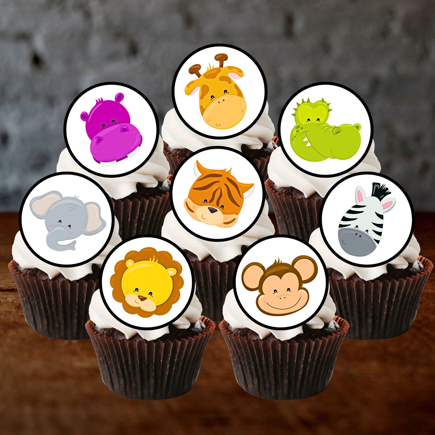 cupcakes with white frosting and cute cartoon jungle animals cupcake toppers. 