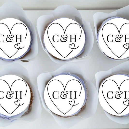 White edible wedding favours with a black romantic heart outline with initials in the middle