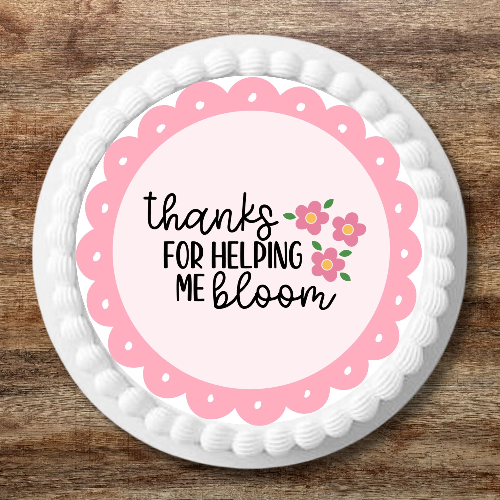 large Thank You For Helping Me Bloom Pink Edible cake Topper on a white iced cake