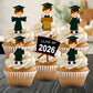 Cupcakes with graduation-themed toppers and 'Class of 2026' sign on a wooden surface.
