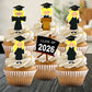 Cupcakes with graduation-themed toppers and a 'Class of 2026' sign.