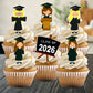 Cupcakes with graduation-themed toppers and a 'Class of 2026' sign.