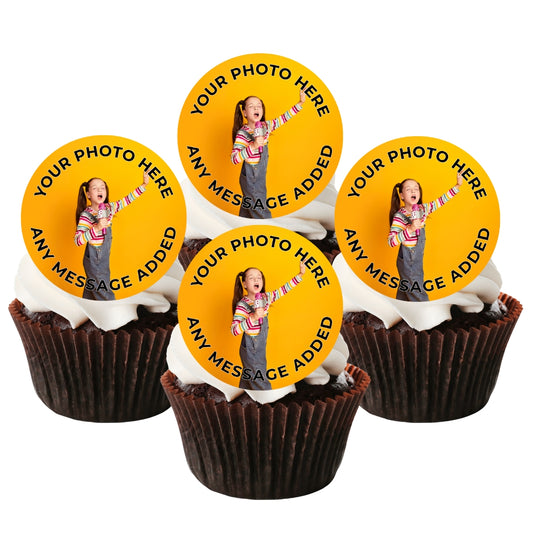 Four cupcakes with white frosting and dark chocolate liners, each topped with a round yellow custom photo topper featuring a placeholder image of a girl and the text 'YOUR PHOTO HERE ANY MESSAGE ADDED'.