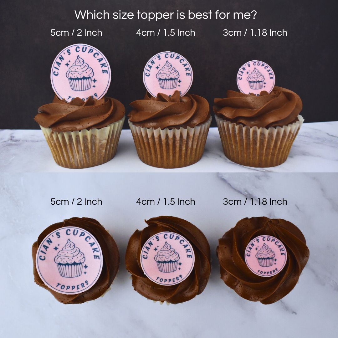 Cupcakes with different sized cake toppers displayed on a marble surface.