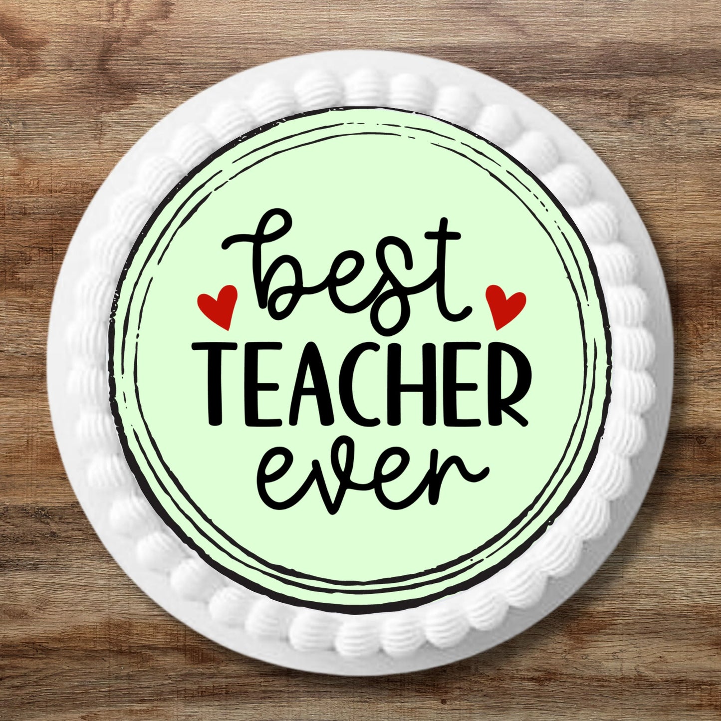 large Best Teacher Ever Edible cake Topper on a white frosted cake 