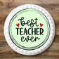 large Best Teacher Ever Edible cake Topper on a white frosted cake 