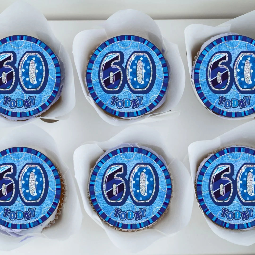 60th Birthday Blue Edible Cupcake Toppers with foil balloon style design on top of frosted cupcakes