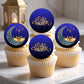 Cupcakes with 'Eid Mubarak' toppers on a white surface.