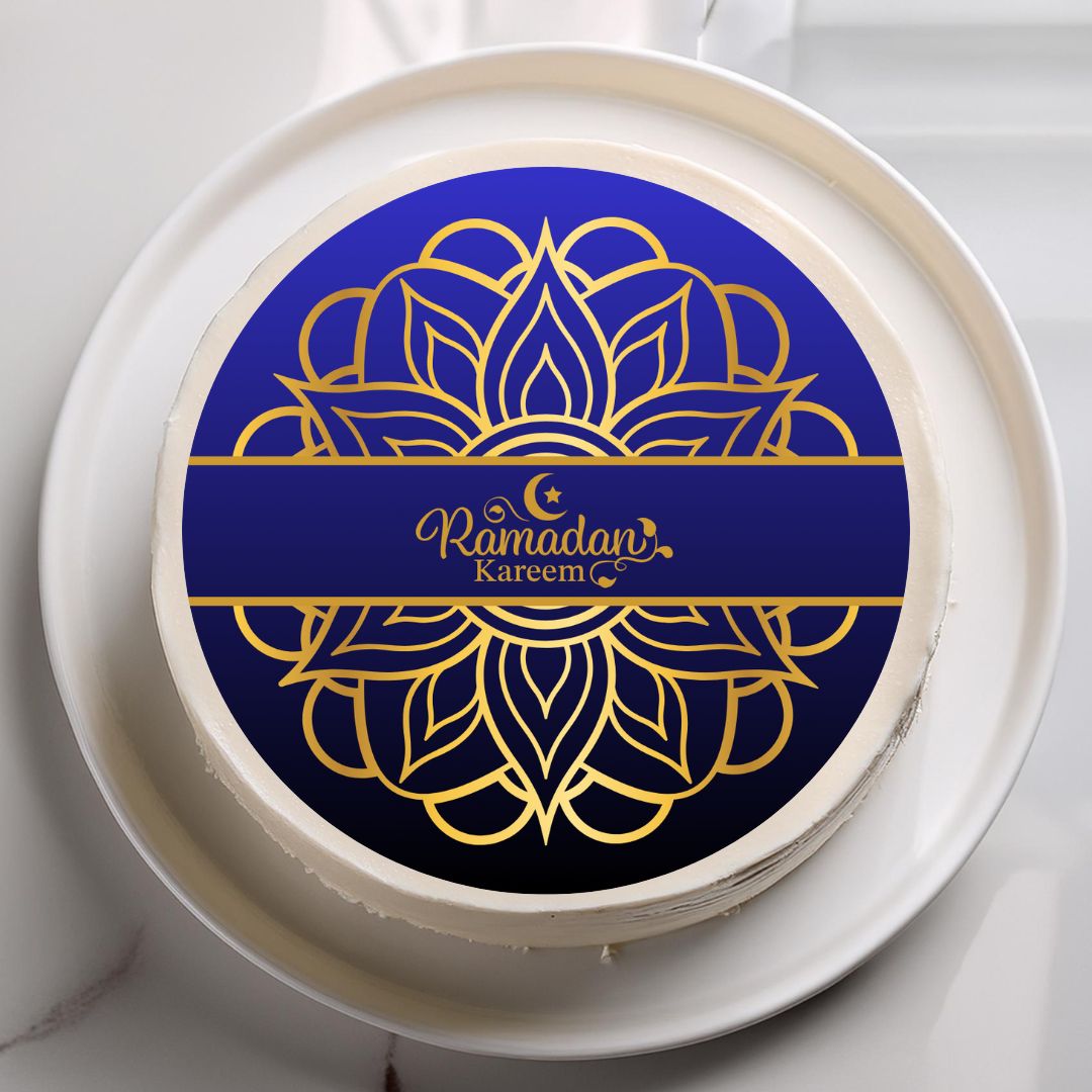 Round cake with 'Ramadan Kareem' design on a white plate