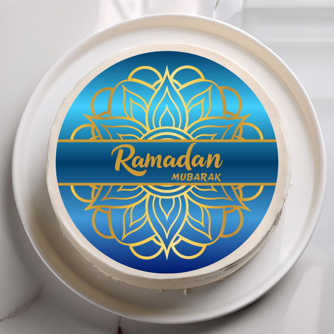Round cake with 'Ramadan Mubarak' design on a white plate