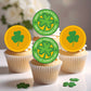Cupcakes decorated with St. Patrick's Day toppers featuring shamrocks and text.