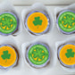 Cupcakes with St. Patrick's Day designs on a white tray