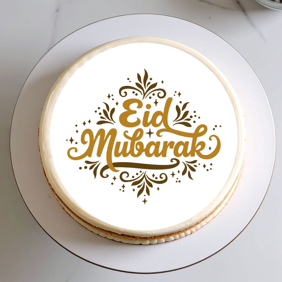 Round cake with 'Eid Mubarak' text on a white plate