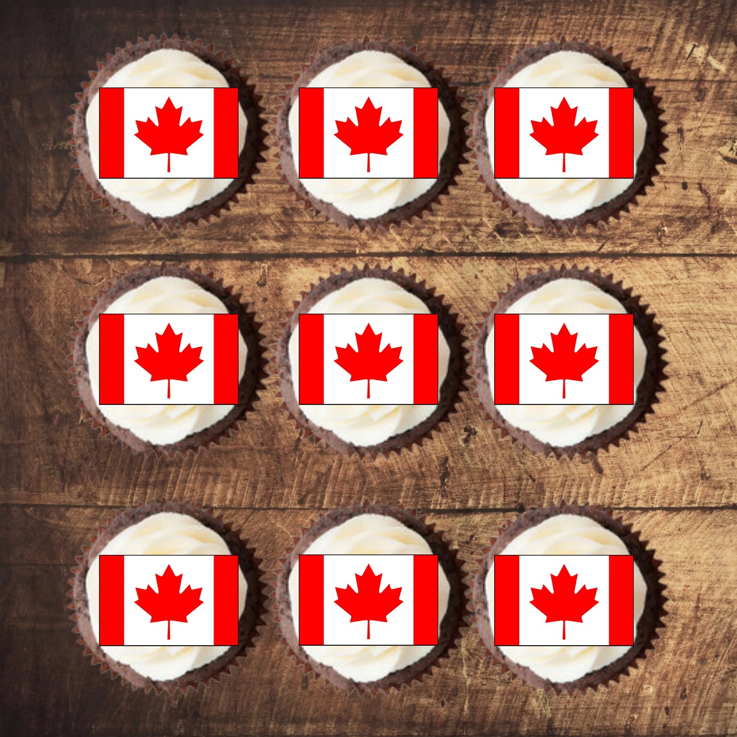 top view of Canadian Flag Edible Cupcake Toppers on chocolate cupcakes with white frosting  