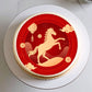 Cake with a horse design on a red background